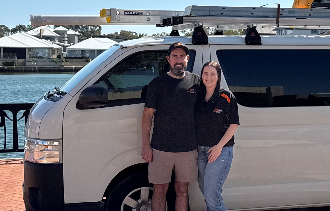 Matthew and Emily McGuire beside a McGuires Electrical service van